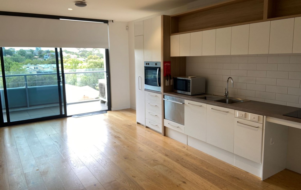 Kitchen in SDA accommodation in Richmond with balcony view