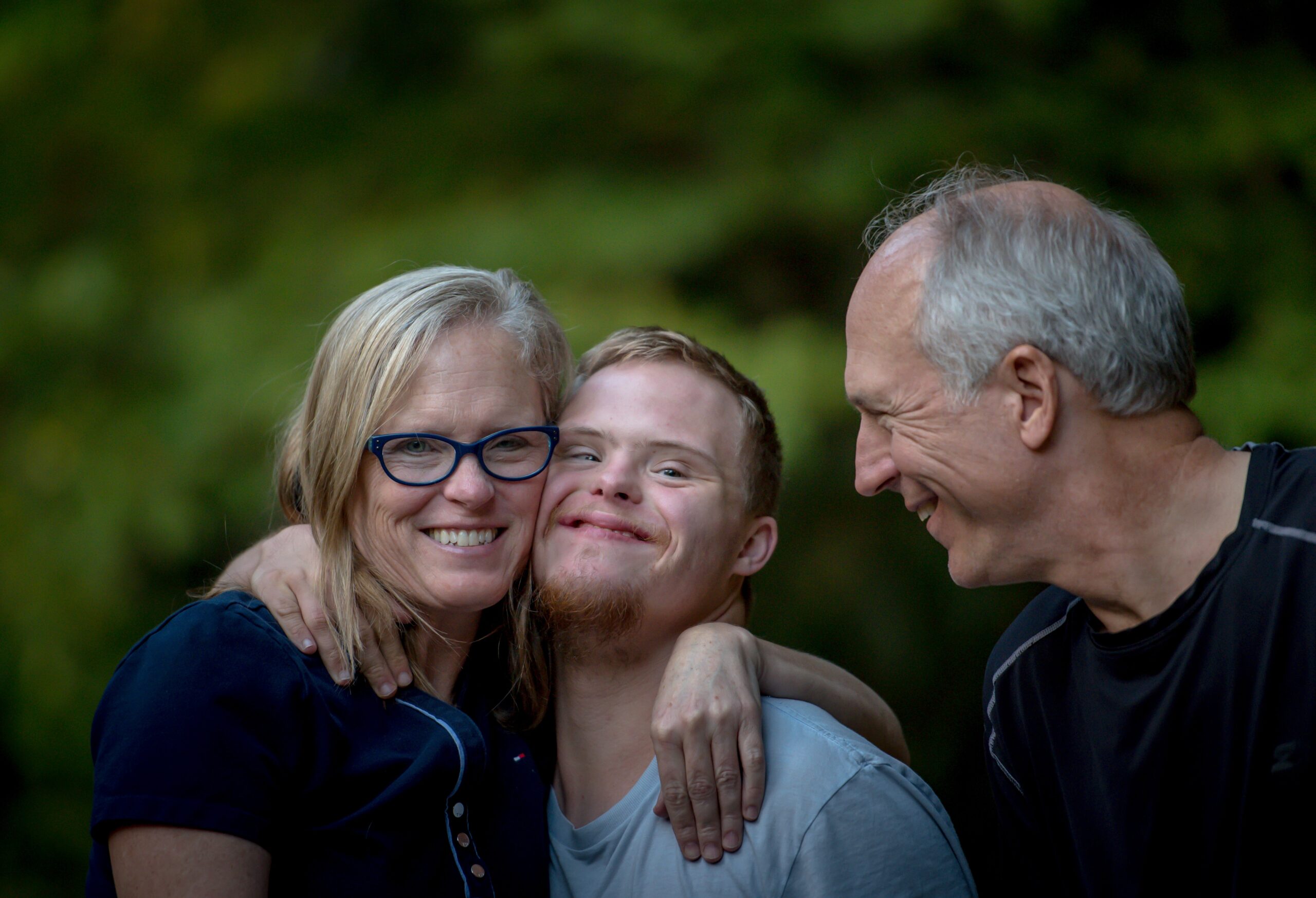 NDIS participant with two family members all smiling